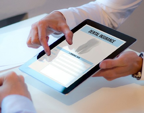 Patient looking at dental insurance form on tablet