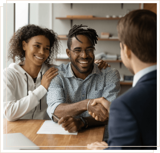 Man shaking hands with man across table