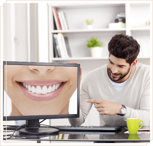 Man pointing to computer monitor showing smile with straight white teeth