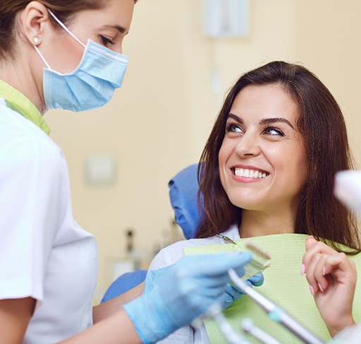 Dentist discussing treatment with patient in dental chair