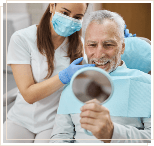 Senior dental patient looking at his smile in mirror