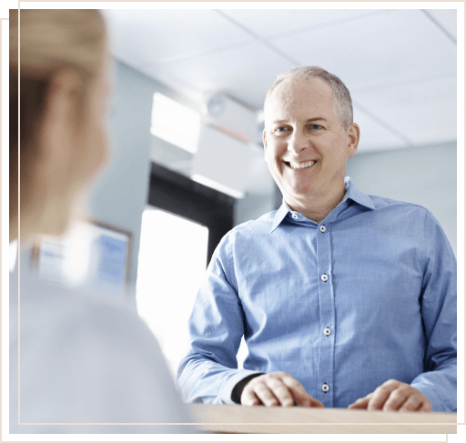 Man smiling at dental receptionist