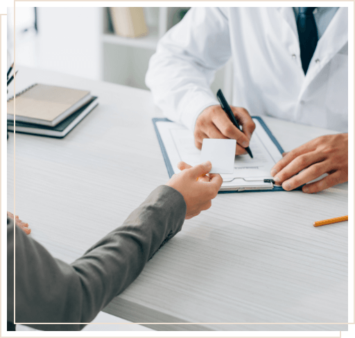 Dental patient handing payment card to their dentist