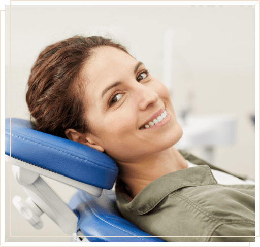 Smiling woman leaning back in dental chair