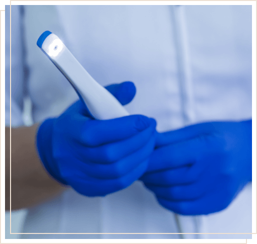 Dental team member holding intraoral oral camera