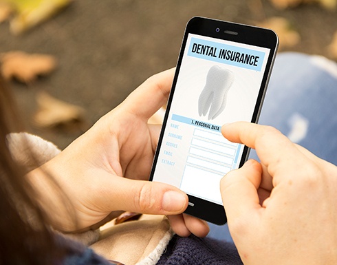 Patient looking at dental insurance form on phone