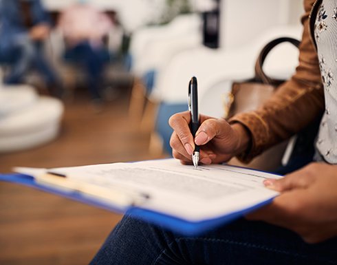 Patient filling out paperwork in lobby