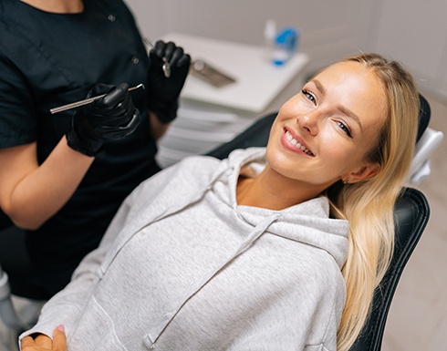 Woman smiling while sitting in treatment chair