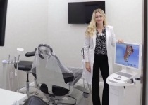 Morristown dentist standing next to computer monitor in dental treatment room
