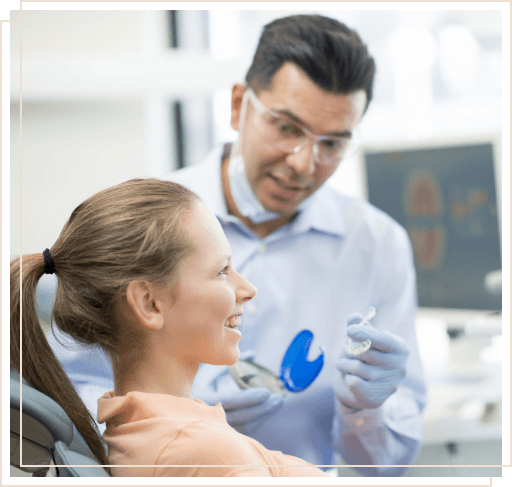 Dentist showing Invisalign aligner to a patient