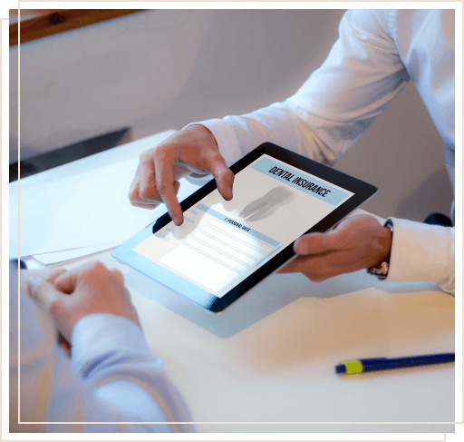Two people looking at dental insurance information on tablet
