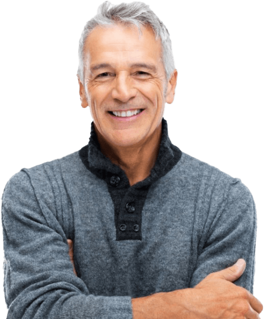 Man in gray sweater smiling after restorative dentistry