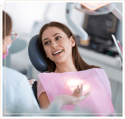 Woman in dental chair talking to her dentist