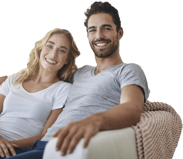 Smiling man and woman sitting on couch together