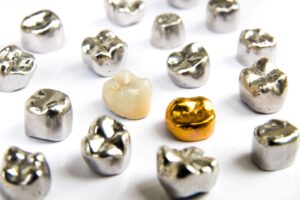 Assortment of metal dental crowns.
