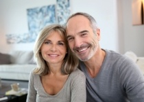 Smiling man and woman in gray sweaters